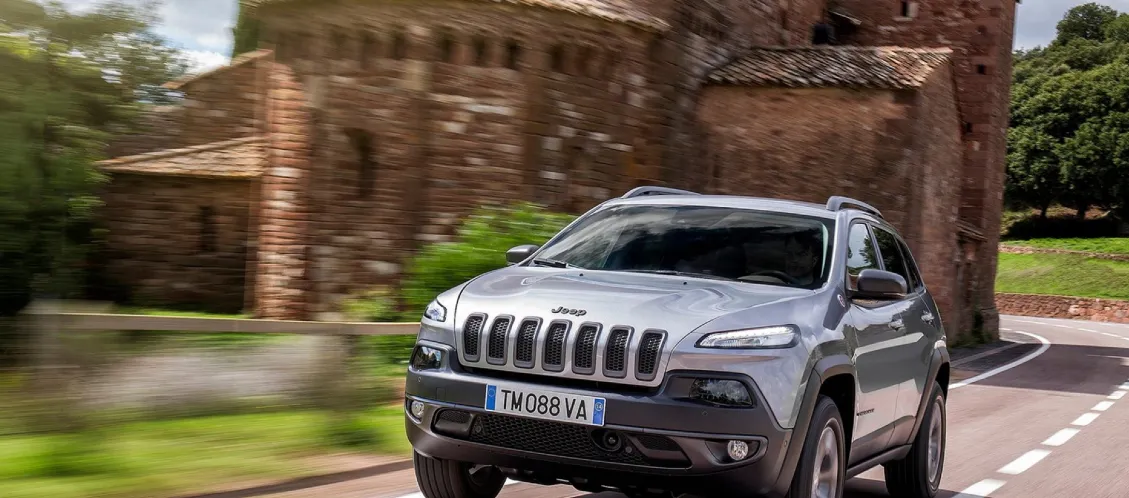 Jeep Cherokee driving through the country in sport mode