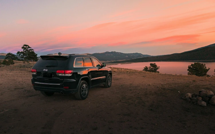 black jeep grand cherokee at sunset