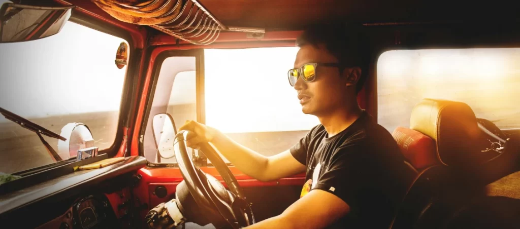 man sitting in the drivers seat of a jeep