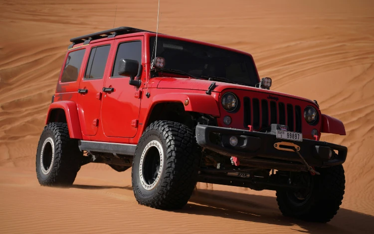 red and black jeep wrangler in the desert